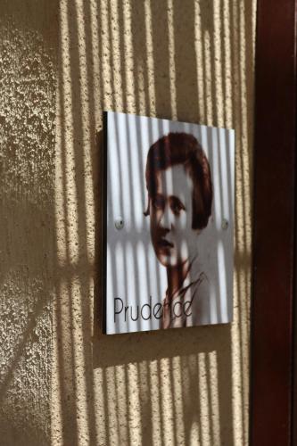 a sign on a wall with a picture of a woman at Louis Henry in Saint-Pierre-des-Champs