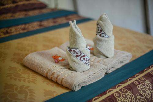 a couple of towels sitting on top of a table at Sairee View Resort in Koh Tao