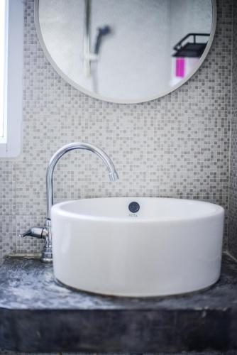 a white sink in a bathroom with a mirror at Sairee View Resort in Koh Tao