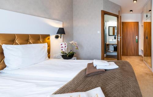 Postel nebo postele na pokoji v ubytování Promocje Amber Park Spa