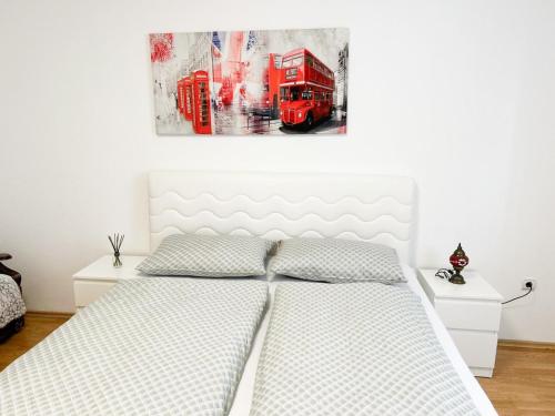a bedroom with a red bus painting on the wall at InstaView Sarajevo - Private parking in Sarajevo