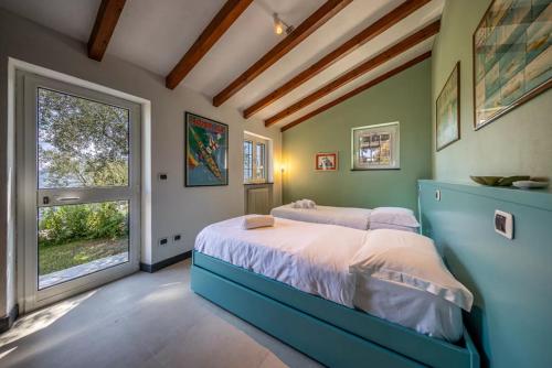 En eller flere senge i et værelse på VILLA SANTINCIELO - Relax tra Cielo e Mare