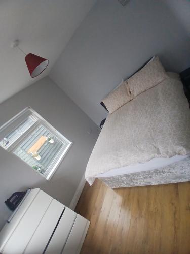 a small bedroom with a bed and a window at D17 Accommodation - Dublin Airport in Dublin