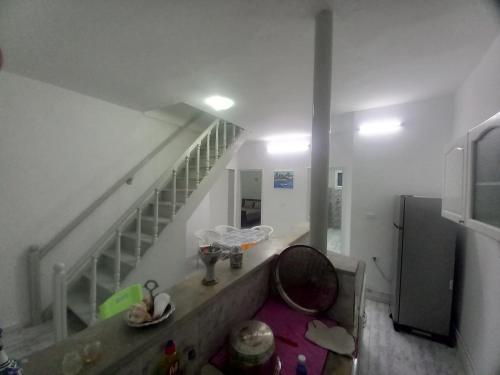 a room with a staircase and a room with a table at Villa Selma in Bin Rhilouf
