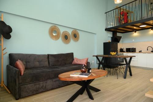 a living room with a couch and a table at Cestrum Suites in Agios Nikolaos