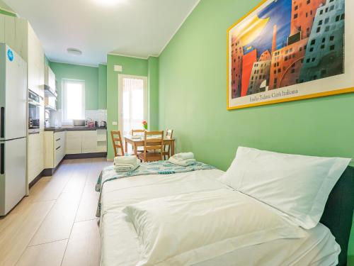 a bedroom with a bed and a kitchen with a table at Niki's House - A due passi dal Lago in Lecco