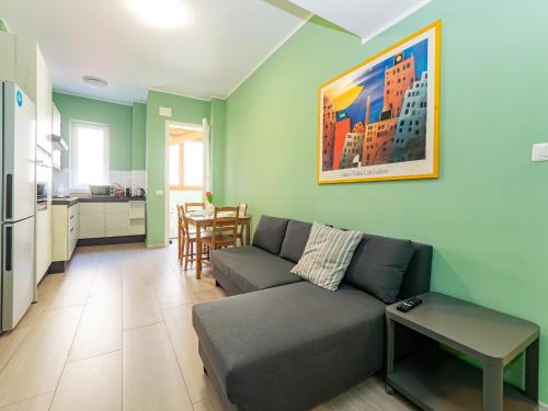 a living room with a couch and a kitchen at Niki's House - A due passi dal Lago in Lecco