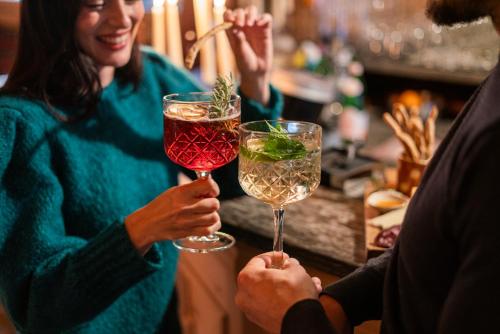 a group of people holding glasses of wine at La Genzianella Bormio in Bormio