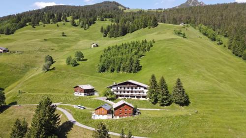 a large green hill with a building on it at Der Alpenfrieden in Marul