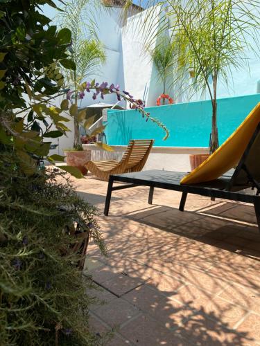 a bench and a hammock next to a pool at Pátio da Villa - Coruche Boutique Guest House in Coruche
