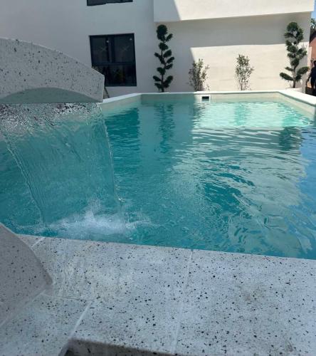 a swimming pool with a fountain in a house at POOL RESORT- Vila Lena- Apartman 2 in Vrdnik