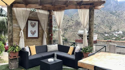 a patio with a blue couch and a table at Casa Jonay in Hermigua