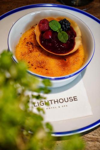 a bowl of food on a plate on a table at Lighthouse Hotel & Spa in Büsum