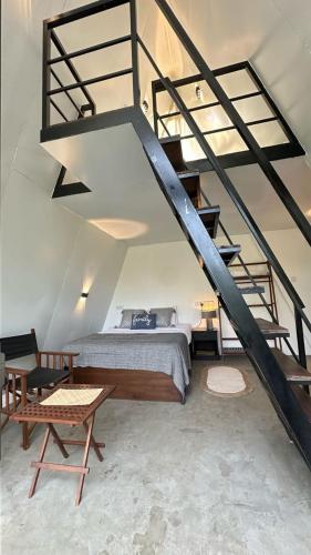 a bedroom with a bed and a staircase at Camp Leopard - Yala Safari Glamping in Yala