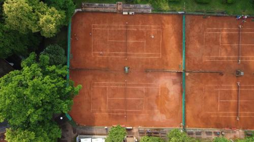 an overhead view of an orange building with trees at Hotel Sport Houštka 