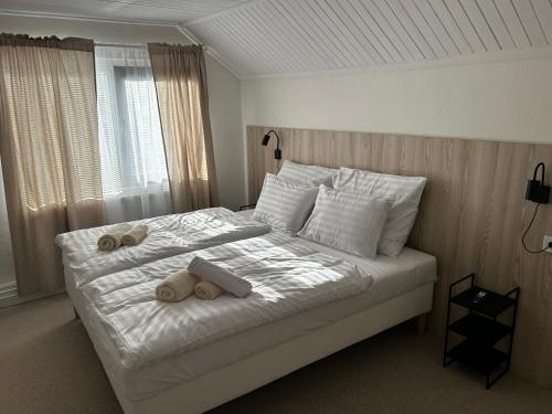 a bedroom with a bed with two teddy bears on it at Hotel Sport Houštka 