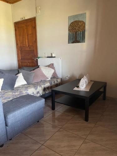 a living room with a couch and a coffee table at Villa Alexandros in Koroni