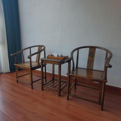 two chairs and a table with a tray on it at Cloud House Of Leisurely in Zhangjiajie