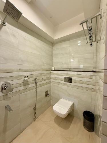 a bathroom with a toilet and a shower at Hotel Ganpati in Siliguri
