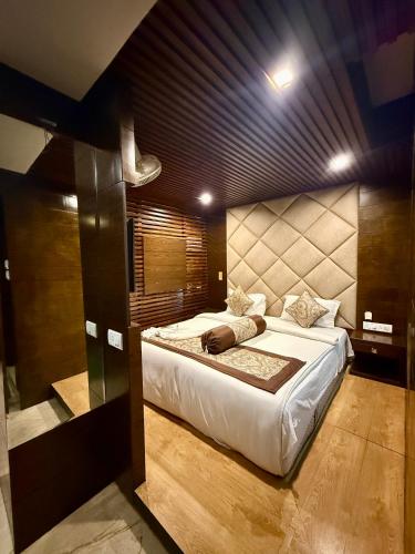 a bedroom with a large bed in a room at Hotel Ganpati in Siliguri