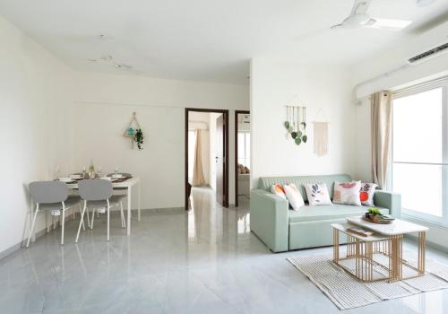 a living room with a couch and a table at Trendy 2bhk Apartment near BKC in Mumbai
