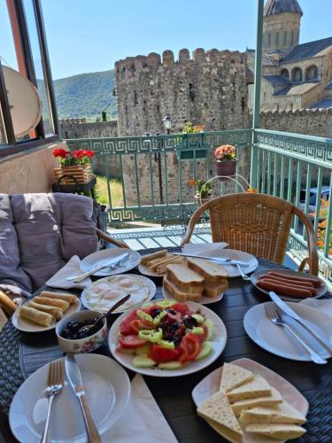 a table with plates of food on top of a castle at Old Capital in Mtskheta
