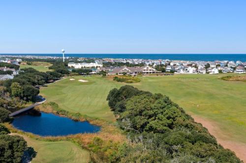 an aerial view of a golf course with the ocean at Live Oak Landing in Corolla