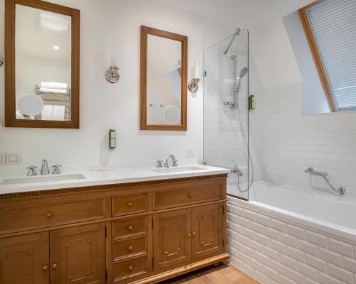 a bathroom with a tub and a sink and a shower at Best Western Plus Market Square Lviv in Lviv