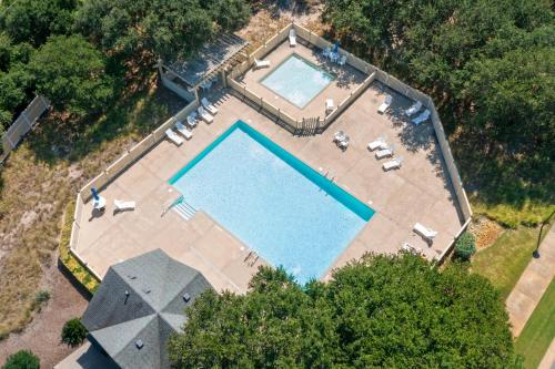 an overhead view of a swimming pool with loungers around it at Live Oak Landing in Corolla