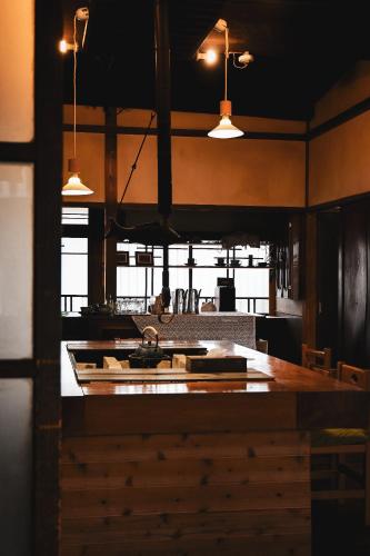 a kitchen with a large island in a room at THE Aramaki 日本の魅力と伝統が詰まった築200年の古民家 1日1組限定貸切 in Ō-naka
