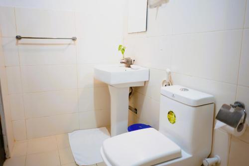 a bathroom with a white toilet and a sink at Camp Leopard - Yala Safari Glamping in Yala