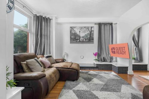 a living room with a couch and a rug at GuestReady - Charming Home in Vibrant Levenshulme in Manchester