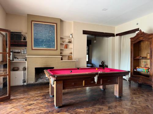 a living room with a pool table and a fireplace at Cabañas La Victoria, Las Calles, Traslasierras, Córdoba in Las Rabonas