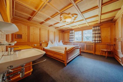 a bathroom with a bed and a sink in it at Zudrellhus in Silbertal