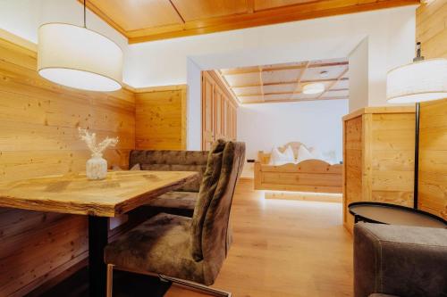 a wooden dining room with a wooden table and chairs at Zudrellhus in Silbertal