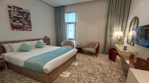 a hotel room with a bed and a television at Jewel Plaza and Aqua Park in Cairo