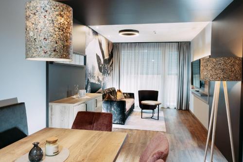 a living room with a table and a couch at Hotel Gasthof Zum Schwanen in Reutte