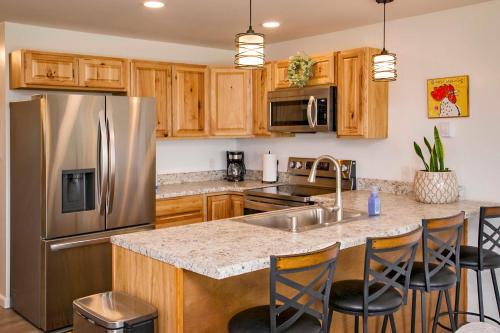 a kitchen with a stainless steel refrigerator and wooden cabinets at Stay Awhile in Bradford