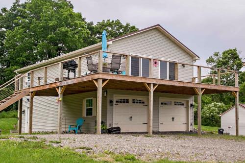 a house with a deck on top of it at Stay Awhile in Bradford
