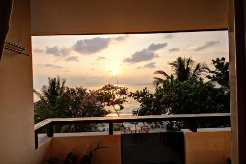 a view of the ocean from a balcony at Beach Villa Hotel Maldives - hotel by the beach in Dhiffushi