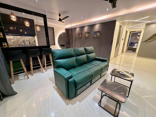 a living room with a green couch and a bar at C Pixels in Bhīmunipatnam