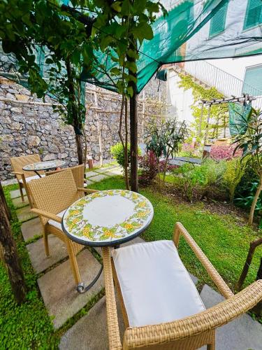 a patio with a table and chairs and a table and chairs at Locanda Costa D'Amalfi in Amalfi