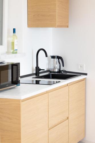 a kitchen with a sink and a microwave at Vista su Fortuna in Palestrina