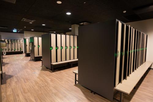 a row of baseball stalls in a locker room at Ring SPA Hostel in Tallinn