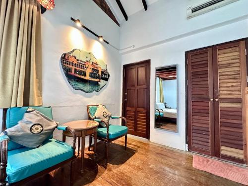 a living room with a blue couch and a table at 26 Rangoon Residence 26 in George Town