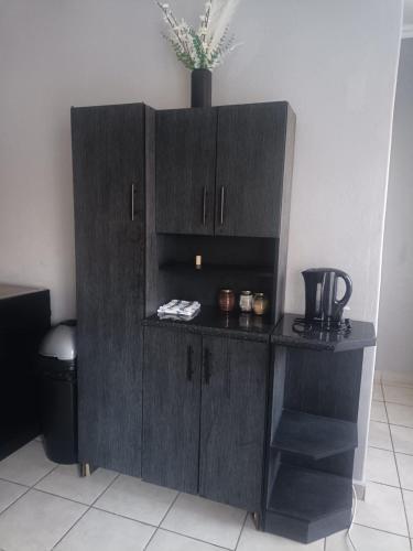a dark wooden cabinet in a room at Home Sweet Home in Polokwane