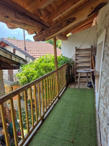 a balcony with a wooden railing and a bench at Casa S Antonio Aradolo in Borgo San Dalmazzo