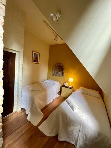 a bedroom with two beds with white sheets at City Flats by Lybeer Hotel Group in Bruges