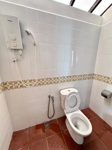 a bathroom with a toilet and a shower at 26 Rangoon Residence 26 in George Town