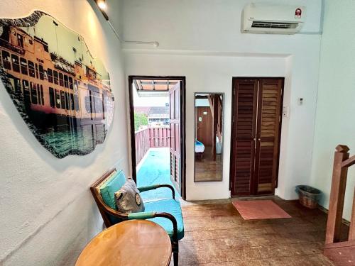 a living room with a blue couch and a table at 26 Rangoon Residence 26 in George Town